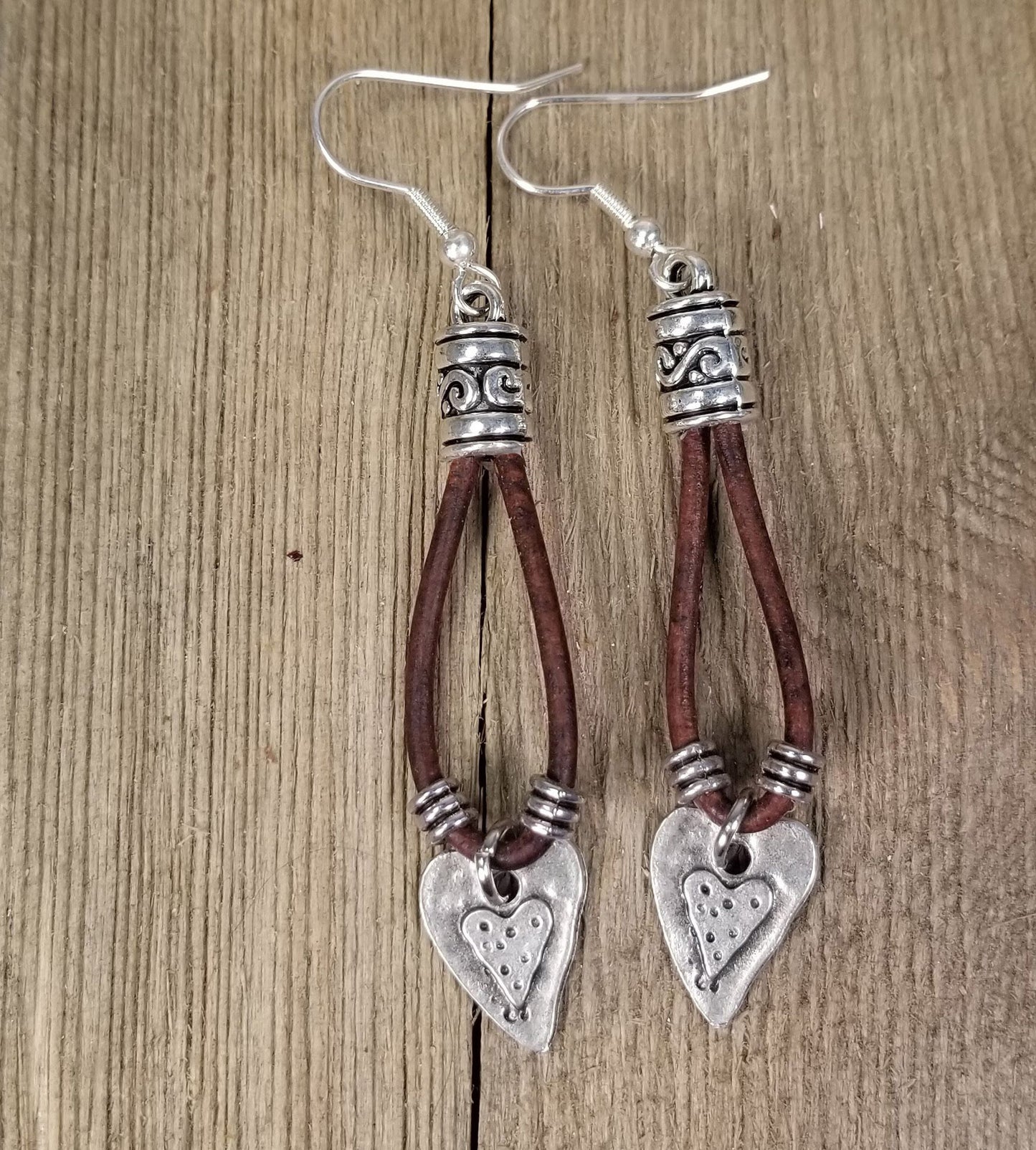 Leather drop earrings with a silver heart, leaf or cross charm